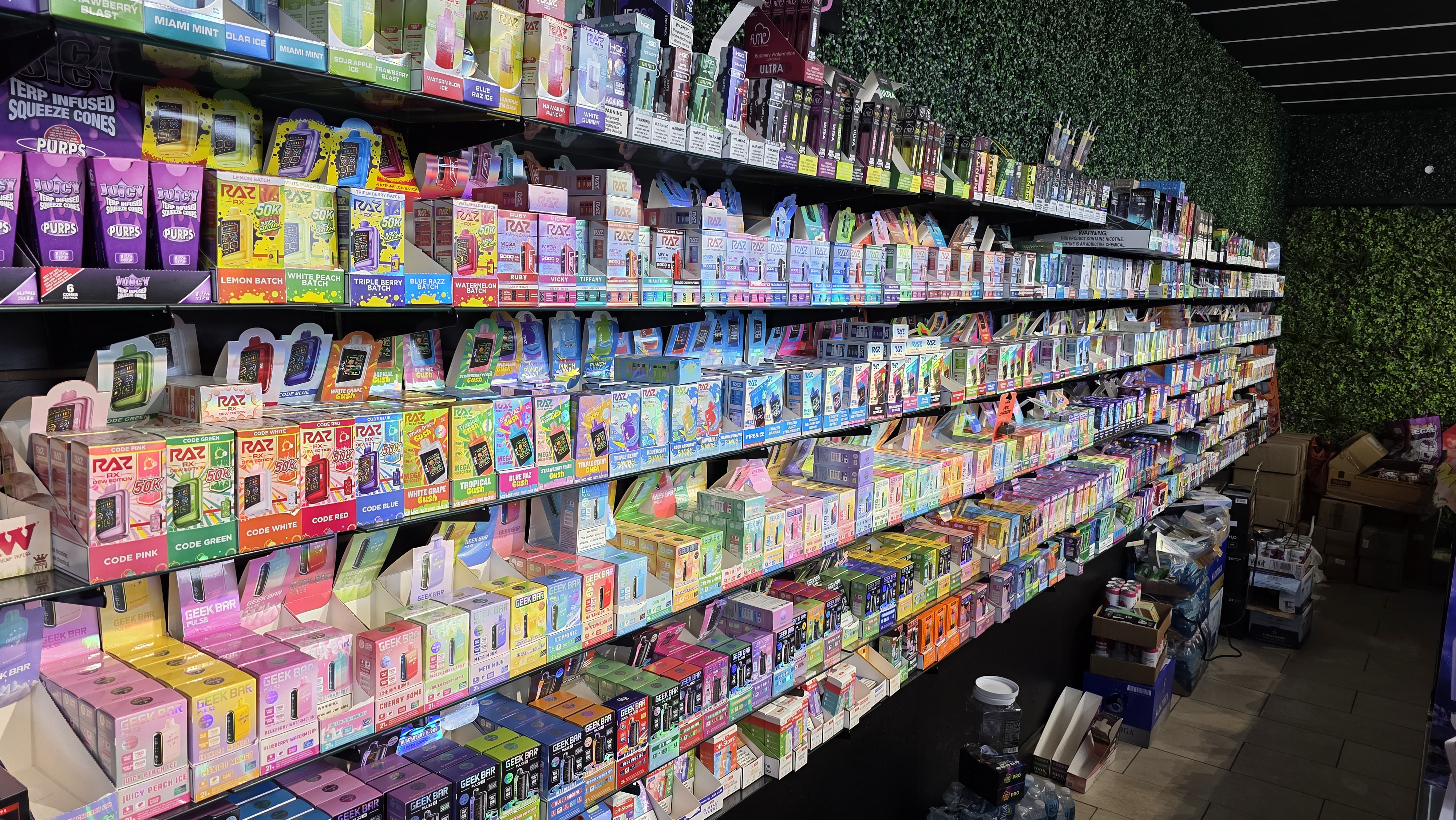 Floor-to-ceiling vape wall with hundreds of flavors